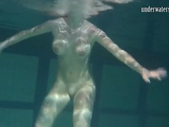 AlphaTeenies presents: Naked brunette with big tits swims solo